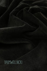 Detail von schwarzem Futterstoff, Material: Baumwollnicki, weich, wärmend, gemütlich, klassisch chic, stilvoll, natürliche Materialien